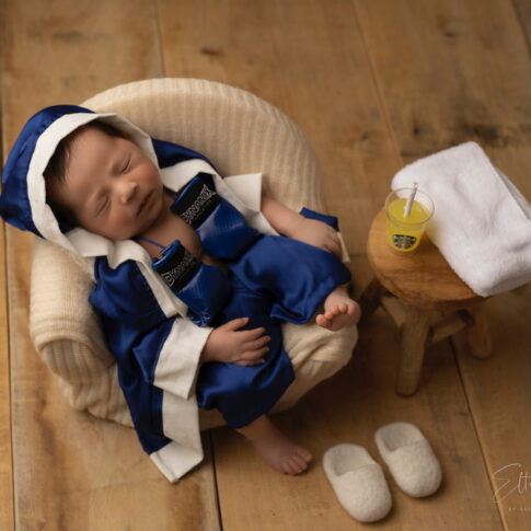 Photo of newborn baby with boxer baby dress concept