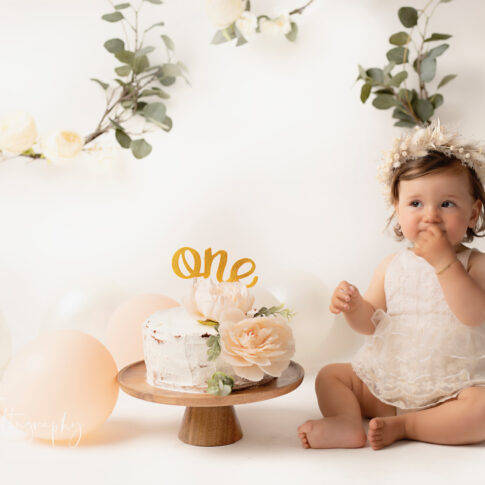 1st birthday concept and photo of baby eating cake